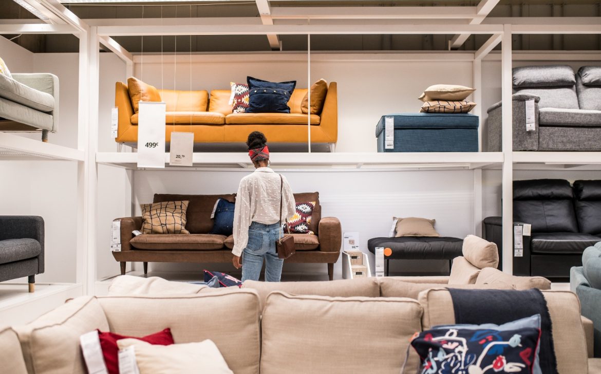 Unrecognizable black female customer choosing furniture in shopping center