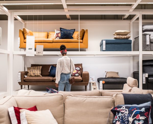 Unrecognizable black female customer choosing furniture in shopping center